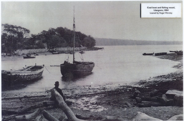 Photograph of a coal boat and fishing vessel on the River Cleddau at Llangwm Pembrokeshire in 1884. The sloop either the Betty or Jane. This was used to bring limestone from Coedcanlas quarries. This was then taken to the lime kilns at Haverfordwest by horse and cart